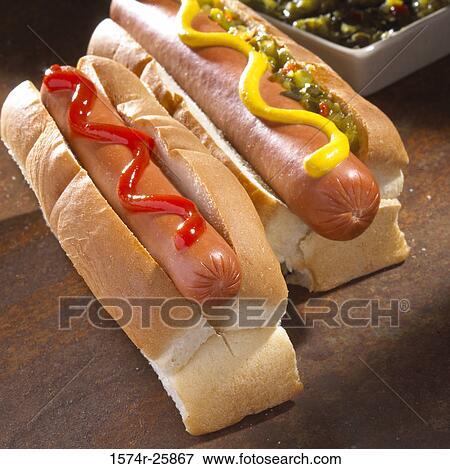 Close-up of two hot dogs with mustard and ketchup View Large Photo Image Stock Photo - Close-up of two hot dogs with mustard and ketchup. Fotosearch