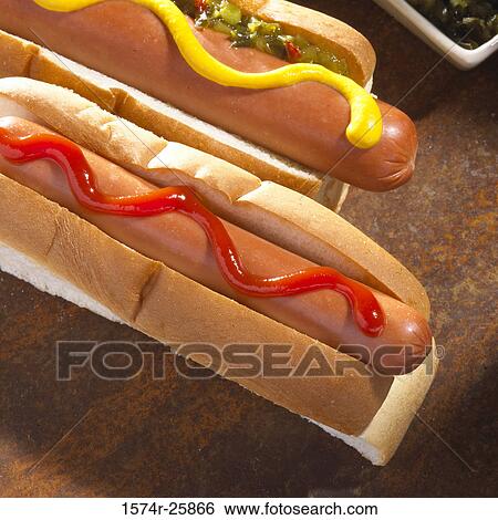 Close-up of two hot dogs with mustard and ketchup View Large Photo Image Stock Photograph - Close-up of two hot dogs with mustard and ketchup. Fotosearch