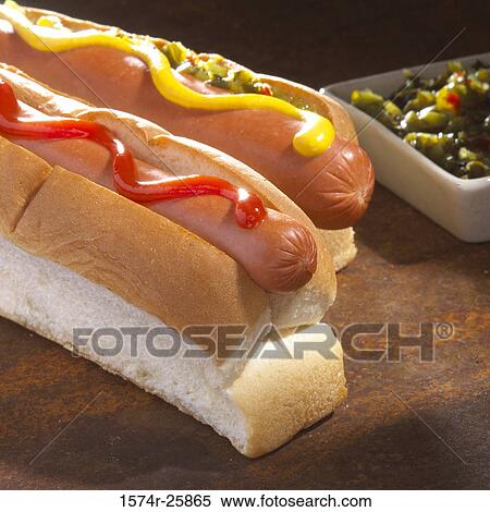 Stock Photography - Close-up of two hot dogs with mustard and ketchup. Fotosearch