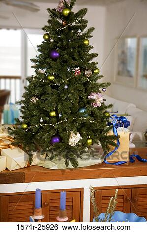 Decorated Christmas tree with gifts in a room View Large Photo Image Stock Photograph - Decorated Christmas tree with gifts in a room. Fotosearch