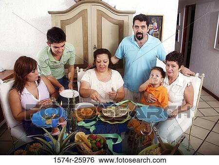 Family at the dining table View Large Photo Image Stock Photograph - Family at the dining table. Fotosearch