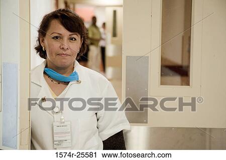 Female doctor standing in a corridor View Large Photo Image Stock Image - Female doctor standing in a corridor. Fotosearch