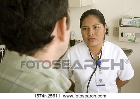Female nurse talking to a patient View Large Photo Image Stock Image - Female nurse talking to a patient. Fotosearch