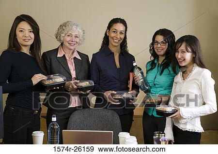 Five businesswomen standing and holding packaged meals View Large Photo Image Stock Photo - Five businesswomen standing and holding packaged meals. Fotosearch