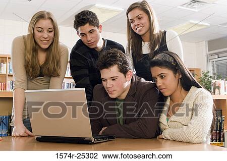 Five students looking at a laptop View Large Photo Image Stock Image - Five students looking at a laptop. Fotosearch