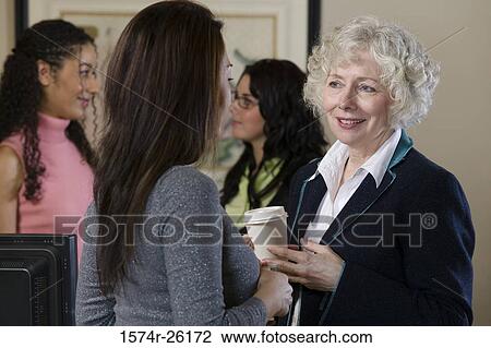 Four businesswoman standing and talking View Large Photo Image Stock Image - Four businesswoman standing and talking. Fotosearch