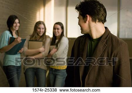 Four students standing in a corridor View Large Photo Image Stock Photo - Four students standing in a corridor. Fotosearch