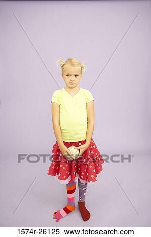 Girl holding a ball and wearing stockings of two different colors View Large Photo Image Stock Photography - Girl holding a ball and wearing stockings of two different colors. Fotosearch