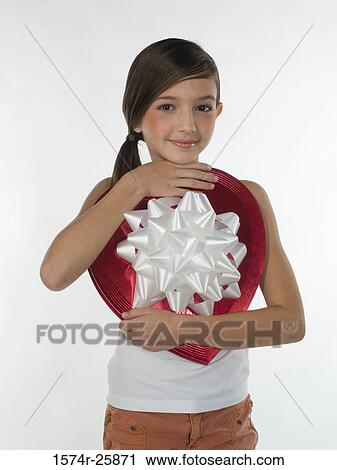 Girl holding a heart shape valentine View Large Photo Image Stock Image - Girl holding a heart shape valentine. Fotosearch