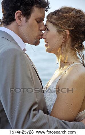 Groom kissing his bride View Large Photo Image Stock Photo - Groom kissing his bride. Fotosearch