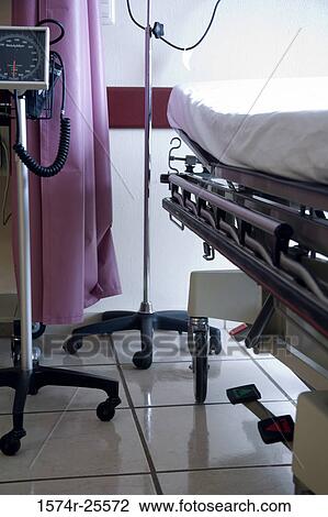 Stock Image - Gurney and an iv drip stand in a hospital ward. Fotosearch