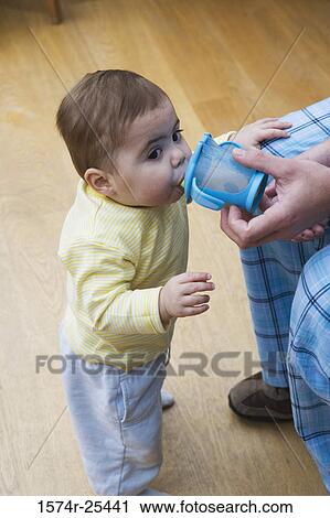 High angle view of a baby boy drinking from a cup View Large Photo Image Stock Image - High angle view of a baby boy drinking from a cup. Fotosearch