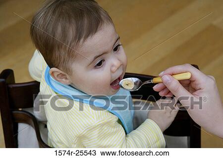 High angle view of a baby boy eating View Large Photo Image Stock Image - High angle view of a baby boy eating. Fotosearch