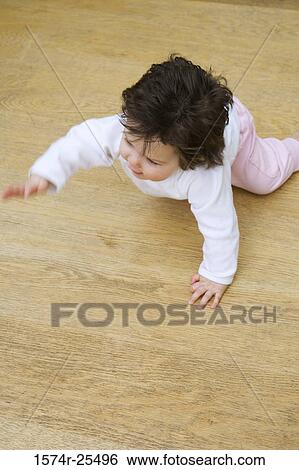 High angle view of a baby girl crawling View Large Photo Image Stock Photograph - High angle view of a baby girl crawling. Fotosearch