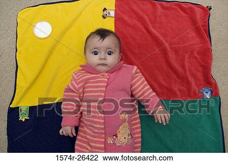 High angle view of a baby girl lying on a blanket View Large Photo Image Stock Image - High angle view of a baby girl lying on a blanket. Fotosearch
