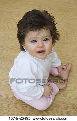 High angle view of a baby girl sitting View Large Photo Image Stock Photography - High angle view of a baby girl sitting. Fotosearch