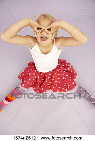 High angle view of a girl pretending to wear eyeglasses View Large Photo Image Stock Image - High angle view of a girl pretending to wear eyeglasses. Fotosearch