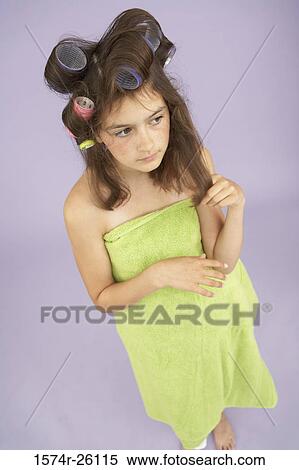 Stock Photography - High angle view of a girl with curlers in her hair. Fotosearch