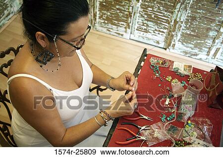 High angle view of a mature woman making jewelry in a souvenir store View Large Photo Image Stock Photo - High angle view of a mature woman making jewelry in a souvenir store. Fotosearch
