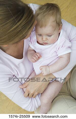 High angle view of a mid adult woman holding her daughter View Large Photo Image Stock Photo - High angle view of a mid adult woman holding her daughter. Fotosearch
