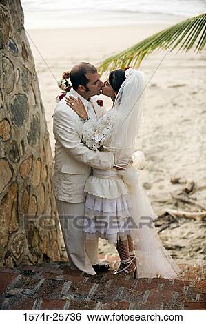 High angle view of a newlywed couple kissing each other View Large Photo Image Stock Photograph - High angle view of a newlywed couple kissing each other. Fotosearch