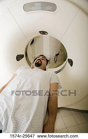Stock Photo - High angle view of a patient getting an MRI scan. Fotosearch