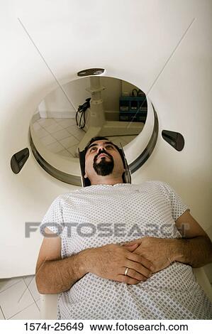High angle view of a patient getting an MRI scan View Large Photo Image Stock Photo - High angle view of a patient getting an MRI scan. Fotosearch