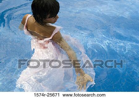 High angle view of a young woman in a swimming pool View Large Photo Image Stock Image - High angle view of a young woman in a swimming pool. Fotosearch