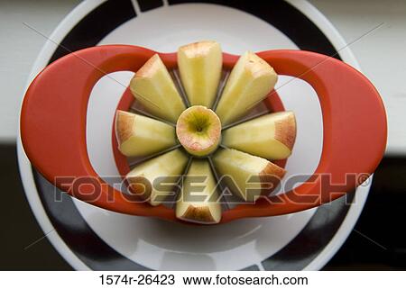 High angle view of apple slices with an apple slicer on a plate View Large Photo Image Stock Image - High angle view of apple slices with an apple slicer on a plate. Fotosearch