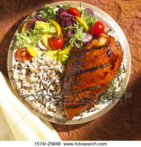 Stock Photo - High angle view of grilled meat with rice on a plate. Fotosearch