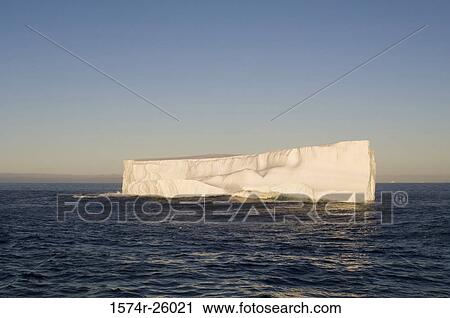 Stock Image - Iceberg floating on water. Fotosearch