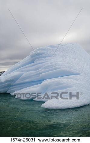 Iceberg floating on water View Large Photo Image Stock Image - Iceberg floating on water. Fotosearch