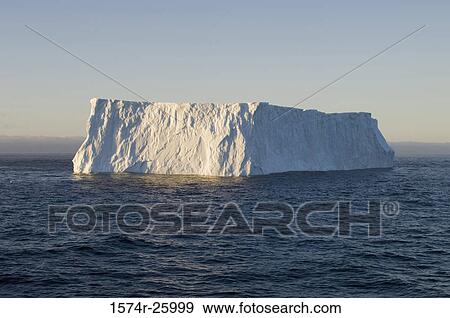 Stock Photo - Iceberg floating on water. Fotosearch