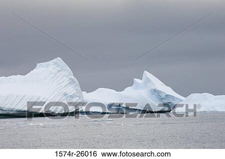 Stock Photograph - Iceberg floating on water. Fotosearch