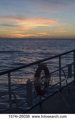 Stock Photo - Life belt hanging on the railing of a boat. Fotosearch