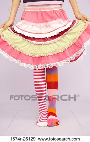 Low section view of a girl wearing stockings of two different colors View Large Photo Image Stock Photo - Low section view of a girl wearing stockings of two different colors. Fotosearch