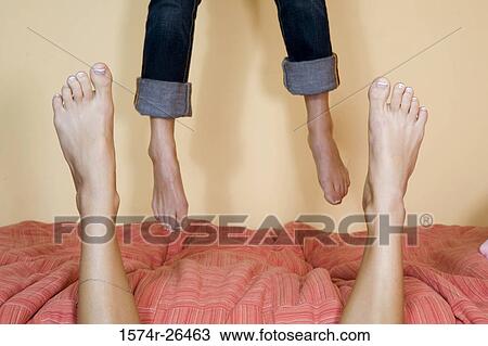 Low section view of a teenage girl jumping on a bed View Large Photo Image Stock Image - Low section view of a teenage girl jumping on a bed. Fotosearch