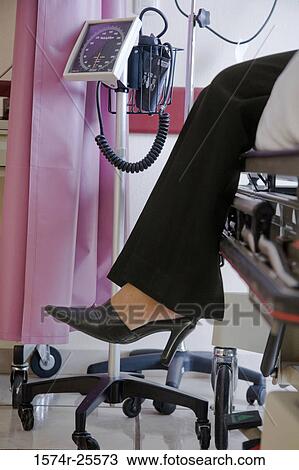 Low section view of a woman sitting on a gurney View Large Photo Image Stock Image - Low section view of a woman sitting on a gurney. Fotosearch