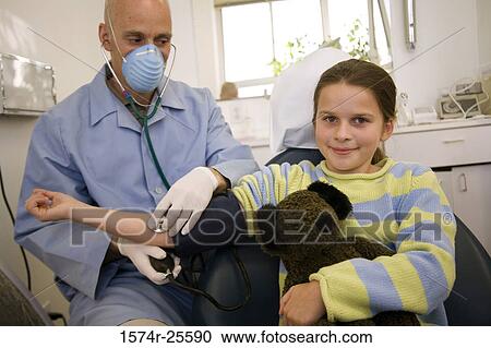Male doctor checking the blood pressure of a patient View Large Photo Image Stock Image - Male doctor checking the blood pressure of a patient. Fotosearch