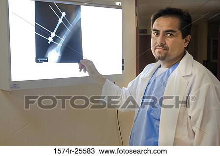 Male doctor holding an x-ray Image View Large Photo Image Stock Image - Male doctor holding an x-ray Image. Fotosearch