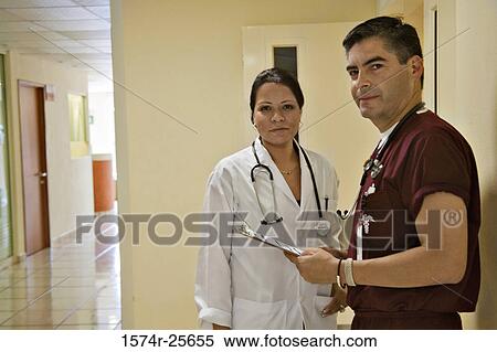 Male doctor standing with a female doctor View Large Photo Image Stock Photography - Male doctor standing with a female doctor. Fotosearch