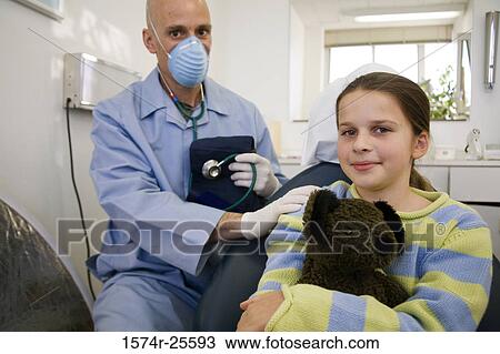 Male doctor with his hands on a patient's shoulder View Large Photo Image Stock Image - Male doctor with his hands on a patient's shoulder. Fotosearch