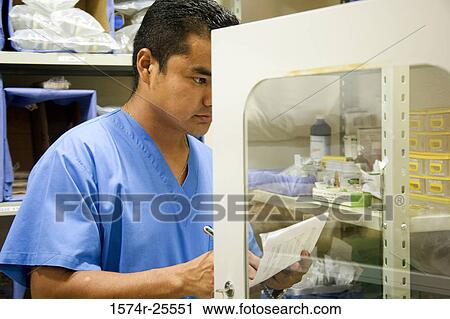 Male nurse making a list of medicine View Large Photo Image Stock Image - Male nurse making a list of medicine. Fotosearch