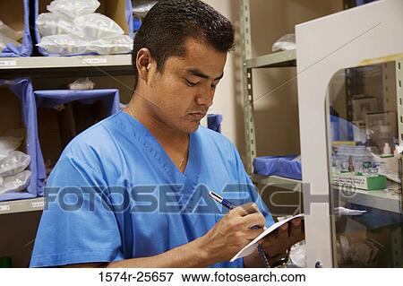 Male nurse making a list of medicine View Large Photo Image Stock Photo - Male nurse making a list of medicine. Fotosearch