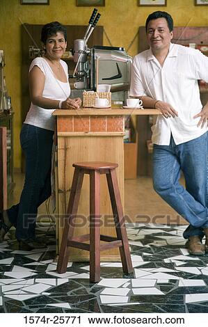 Mature couple leaning against a counter in a cafe View Large Photo Image Stock Image - Mature couple leaning against a counter in a cafe. Fotosearch