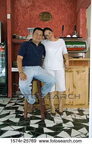 Mature couple smiling in a cafe View Large Photo Image Stock Photo - Mature couple smiling in a cafe. Fotosearch