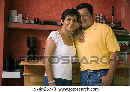 Mature couple standing in front of a counter in a cafe View Large Photo Image Stock Image - Mature couple standing in front of a counter in a cafe. Fotosearch