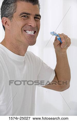 Mature man brushing his teeth View Large Photo Image Stock Photo - Mature man brushing his teeth. Fotosearch