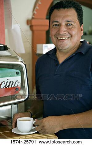 Mature man holding a cup of coffee and smiling in a cafe View Large Photo Image Stock Image - Mature man holding a cup of coffee and smiling in a cafe. Fotosearch