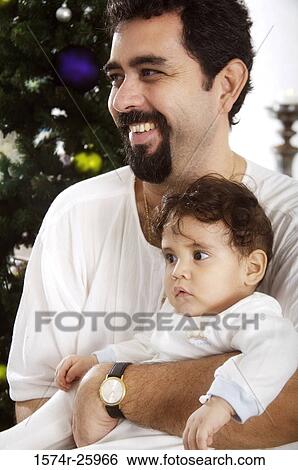 Mature man holding his baby and smiling View Large Photo Image Stock Photograph - Mature man holding his baby and smiling. Fotosearch